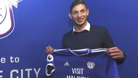 AFP Sala posing with a Cardiff City shirt on 20 January