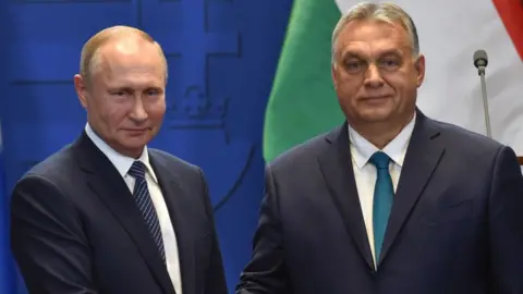 Getty Images Hungarian Prime Minister Viktor Orban (R) and Russian President Vladimir Putin shake hands after a press conference at the residence of the prime minister office in Budapest on October 30, 2019.