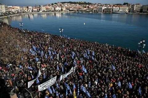 Getty Images Residents of the island of Lesbos take part in a demonstration against migrant camps, at the port of Mytilene, 22 January 2020