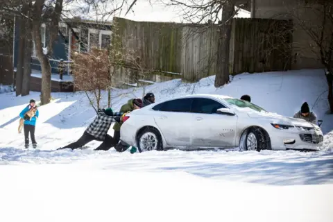 Montinique Monroe / Getty I,ages Car stuck in the snow