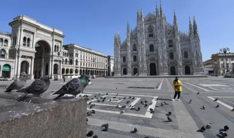 DANIEL DAL ZENNARO / EPA The deserted Piazza Duomo in Milan, Italy