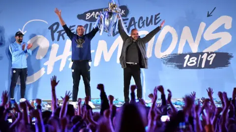 PA Vincent Kompany and Pep Guardiola