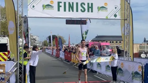 BBC Guillaume Ruel crosses the finish line at the 2024 Guernsey Marathon