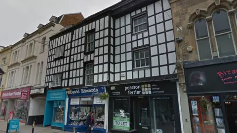 Google An old building above shops