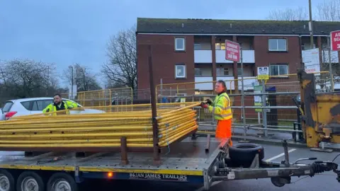 Workers taking down barriers