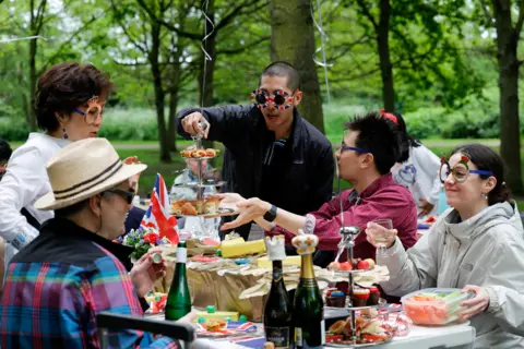 Reuters People celebrate Britain's King Charles' coronation with the Big Lunch at Regent's Park, in London, Britain, May 7, 2023