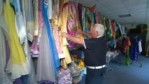 Owen Money looking at pantomime costumes