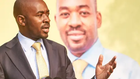 AFP CCC leader Nelson Chamisa in front of a poster of himself in August 2023