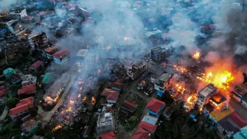 Getty Images A village in Chin State in flames because of shelling from Junta military troops