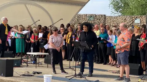 Monica Ferguson Rommi Smith speaks at the event where the 250 voices choir performed