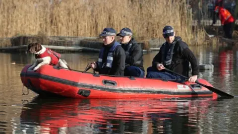 PA Media Police officers in a RIB search Eagle Pond on Clapham Common