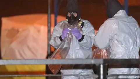 Getty Images Police in protective suits in Salisbury on 13 March 2018
