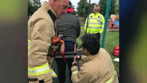 Suffolk Police Firefighters releasing man from swing