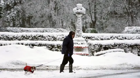 PA Media Man walking his dog in Allenheads, Northumbria