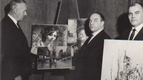 Art Recovery International FBI agents standing next to stolen paintings that have been recovered