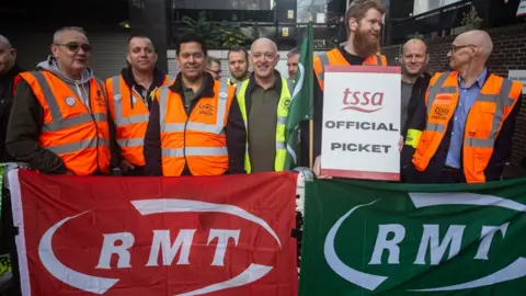 Getty Images Members of the RMT, TSSA and ASLEF staff join the picket line at Euston station