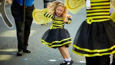 Mark Waugh girl in bee costume dances