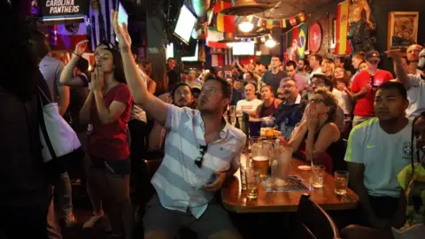 BBC US fans gesticulate during the match