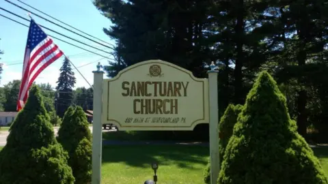 Newfoundland Sanctuary Church Facebook Sign outside church with American flag