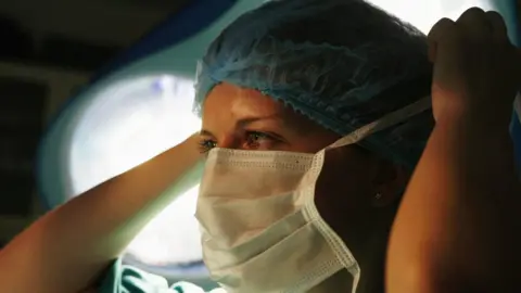 Doctor adjusting mask