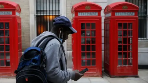 Getty Images A man checking his phone