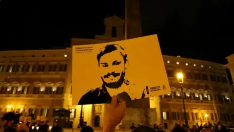 Reuters Demonstration on second anniversary, someone holds an image of Regeni