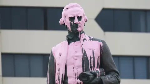 LEIGH HENNINGHAM A statue of Captain Cook covered in pink paint