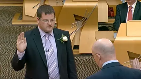 Mark McDonald being sworn in