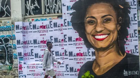 NurPhoto via Getty Images A wheat-paste piece of street art by artist Luis Bueno shows the councilwoman from Rio de Janeiro Marielle Franco. File photo