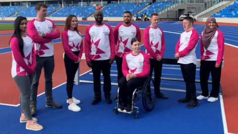 Nine of the baton-bearers at the Alexander Stadium