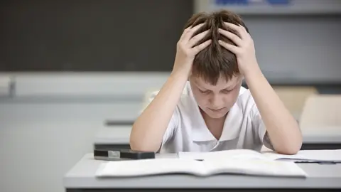 Getty Images schoolboy concentrating on his work