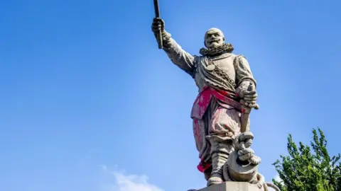 Getty Images A statue of Dutch Lieutenant and admiral of the West India Company is covered in paint