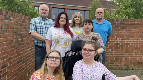 BBC/Jim Scott Councillors Michael Hartnack and Simon Ayre join parents Emma, Pam and Tracy