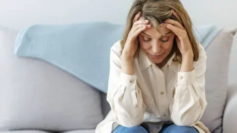 Getty Images Woman with Covid symptoms at home