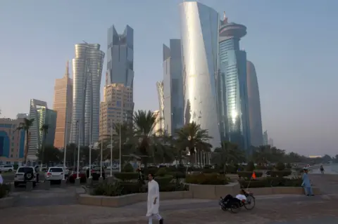 Reuters A man walks on the corniche in Doha, Qatar, 15 June