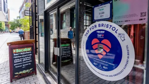 Bristol City Centre BID A TAP donation point on the side of a shop