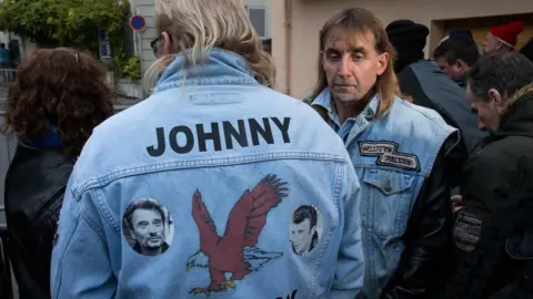 Getty Images Fans of Johnny Hallyday gather outside his house in Marnes-la-Coquette, 6 December 2017