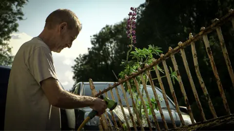 Ystalyfera resident Chris Jones watering his garden