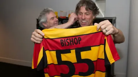 Callum Mills John Bishop is presented with a Partick Thistle shirt