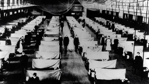 Universal History Archive/Getty Images A warehouse being used as a makeshift hospital for flu patients in 1918