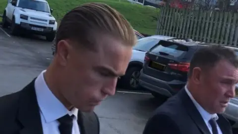 BBC Two men in suits arrive at court