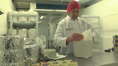 Stilton cheese being wrapped at Hartington Creamery