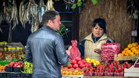 Getty Images Market trader and customer in Moscow