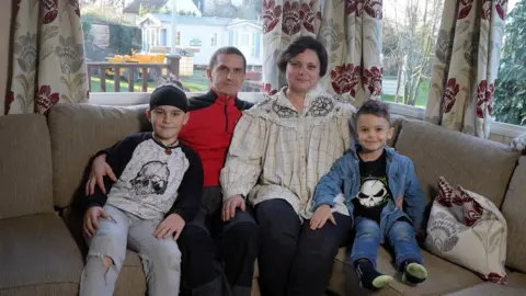 Jamie Niblock/BBC The Yevstihnieieva family. 10-year-old Nazar, his father Dmydro, his mother Hanna and 4-year-old Daniil