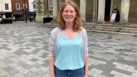 Liberal Democrat Councillor Victoria Charleston stood in front of Salisbury's Guildhall