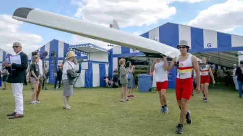 PA Media Rowers carrying boat