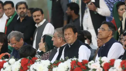 Getty Images Pakistan's Prime Minister Imran Khan (second from right) held a rally ahead of a no-confidence vote against him in Islamabad, Pakistan on 27 March