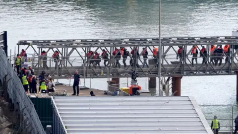 GARETH FULLER/PA WIRE A group of people were taken to Dover, Kent from a Border Police ship on Friday.