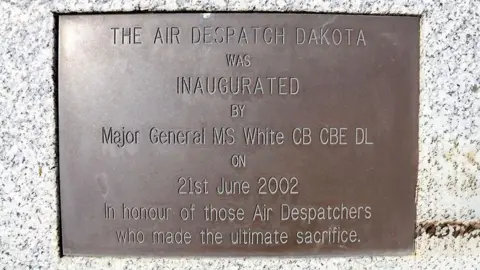 RAF Brize Norton A plaque on the stone tag that reads "The air dispatch Dakota was inaugurated by major General MS White CB CBE DL on 21 June 2002 in honour of those Air Dispatchers who made the ultimate sacrifice."
