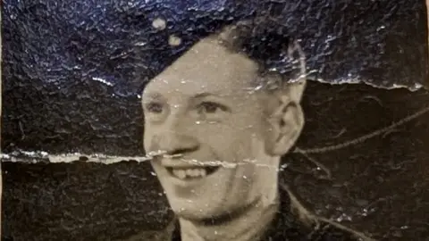 Greg Horsford An imagine of Sgt Harry Clarke, one of four crew members that died in the plane crash in April 1942. He is in full military uniform and is smiling 